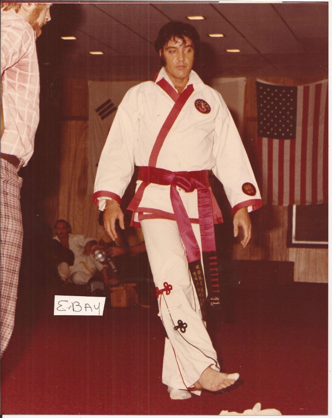 Elvis Presley walking across the dojo floor in his Pasaryu gi